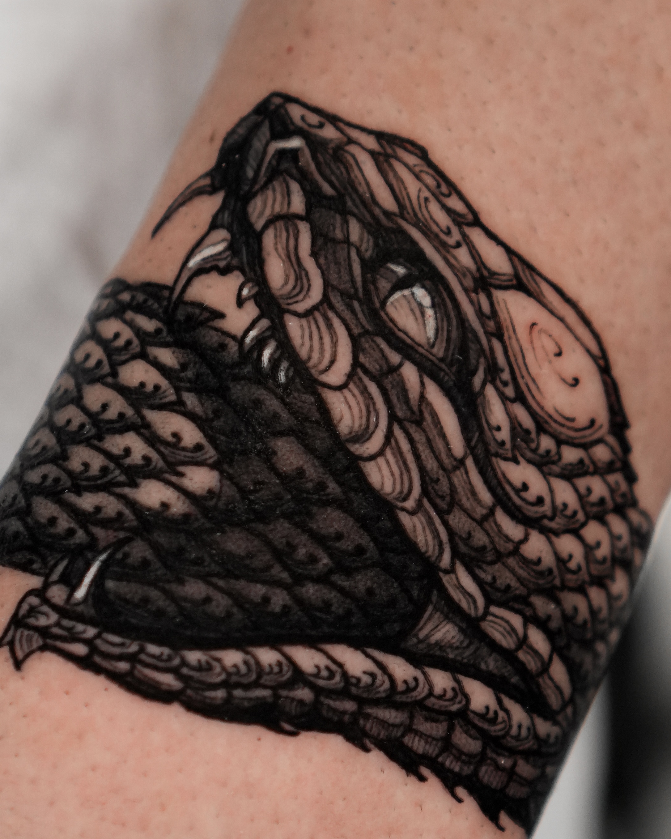 Graphic blackwork serpent tattoo